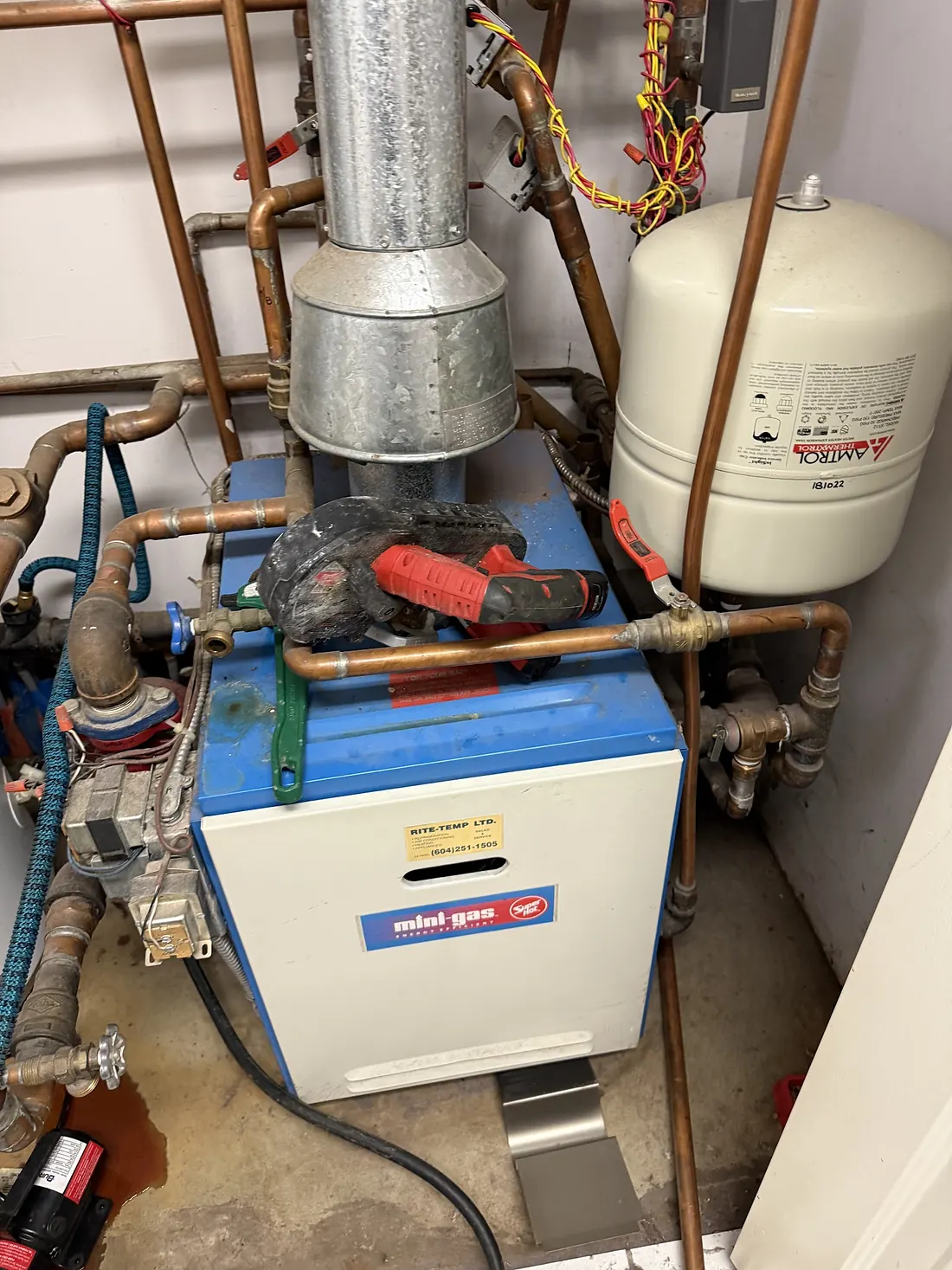 Gas-fired hydronic boiler with copper supply and return piping mounted in a residential mechanical room