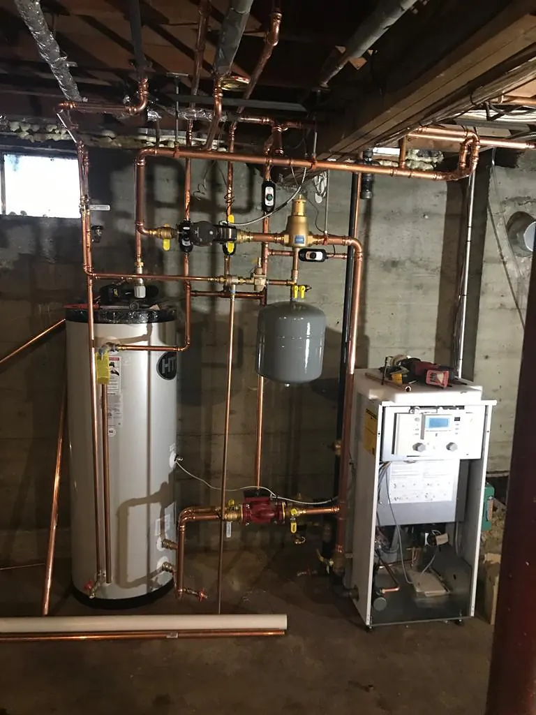 Mechanical room with a water heater, boiler and copper piping